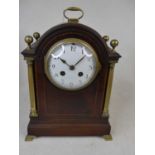 An Edwardian mahogany and barber-pole strung mantel clock, the enamelled dial showing Arabic