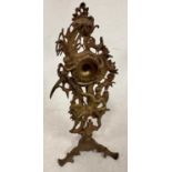 An early 19th century gilt metal easel pocket watch stand, decorated with Old Father Time,