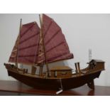 A hardwood model of a Chinese junk boat, length 81cm