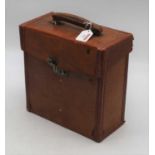 An early 20th century leather travel case containing various leather clad road maps, each with