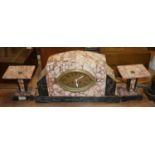 An Art Deco rouge and black marble cased clock garniture, the central clock having an oval brass