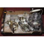 A box of silver plated items to include a Victorian kettle on stand with burner and other tea wares