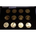 A cased set of John Le Pinche's Treasures of Pompeii gold plated on bronze medallions housed in