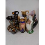 A collection of pottery items, to include a fish jug, tube-line decorated vase, and a pair of