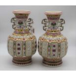 A pair of reproduction Chinese export vases, each of baluster form having reticulated body in the