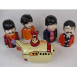 A Lorna Bailey pottery model of The Beatles Yellow Submarine; together with a similar set of four