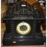 A Victorian black slate mantel clock, the enamelled chapter ring showing Arabic numerals, the
