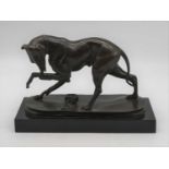 A modern bronze modelled as a dog, in standing pose licking its raised paw, on marble plinth, w.30cm