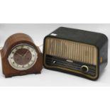 A 1950s walnut cased mantel clock, having a silvered dial with Arabic numerals, the eight-day