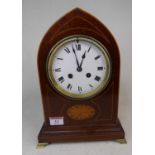 An Edwardian mahogany and boxwood strung mantel clock, the enamelled dial showing Roman numerals,