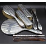 A George V silver dressing table set to include hand mirror, hair brush, clothes brushes, comb, shoe