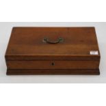 An early 20th century oak box, the hinged lid with brass handle, with paper label to the