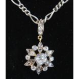 A late Victorian white metal flower shaped cluster pendant, featuring a centre old cushion cut