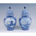 A pair of Royal Mosa blue and white urns, 20th century, the lids surmounted by lion finials, each