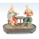 A 19th century polychrome painted pottery nodding-head tableau of card-players, modelled as two