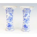A pair of Delft blue and white trumpet vases, 19th century, each decorated with courting couples,