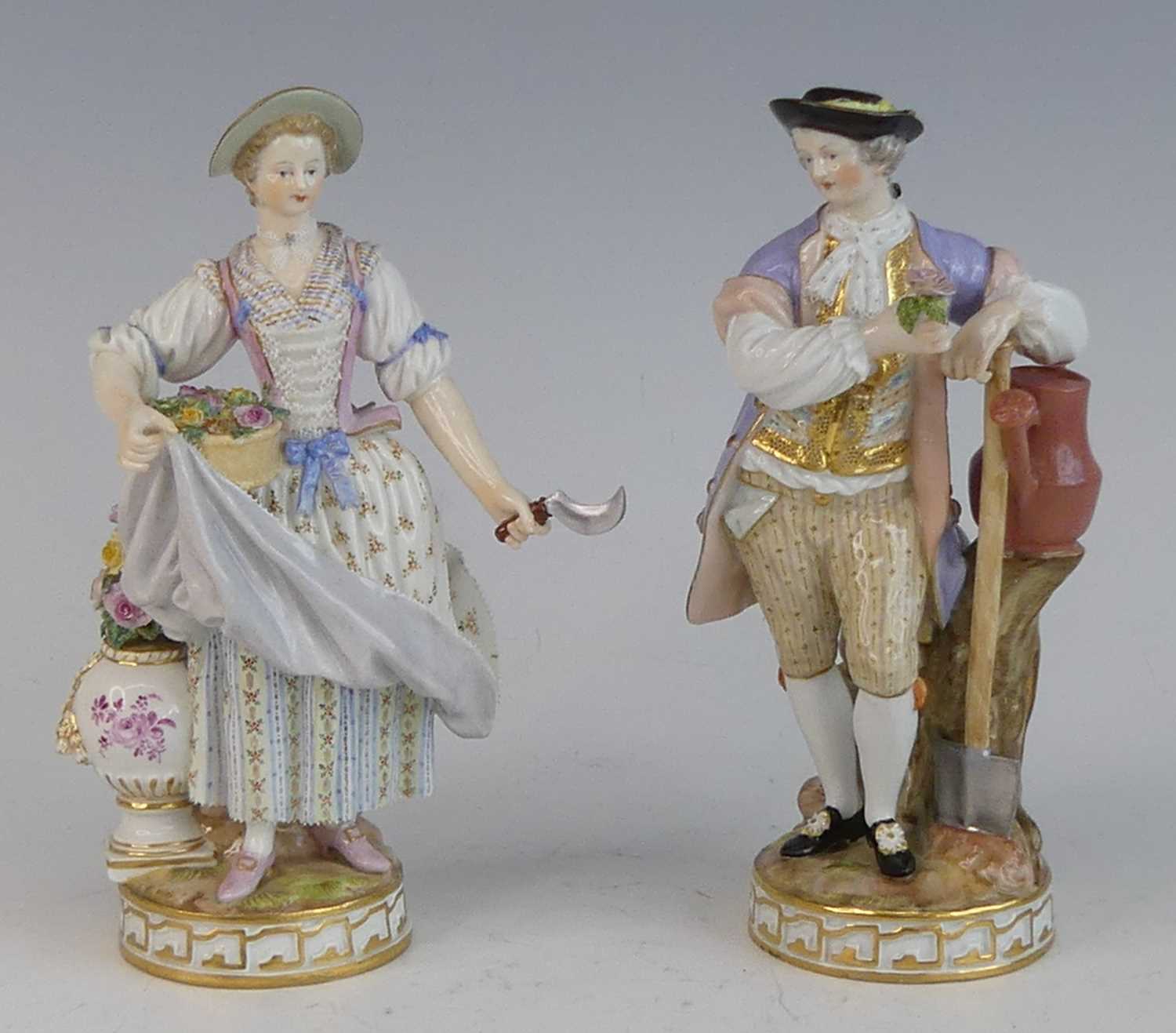 A pair of Meissen porcelain figures of gardeners, late 19th century, each shown in 18th century