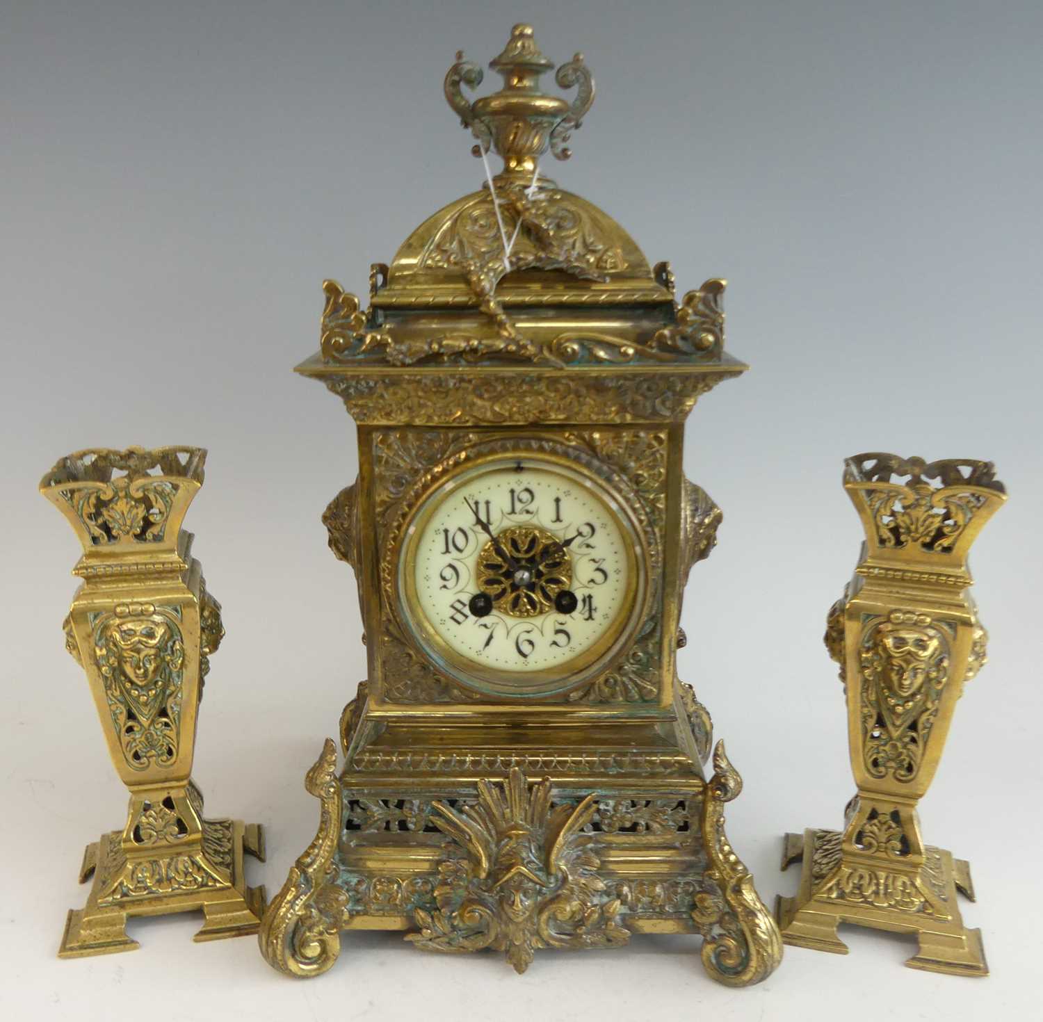A late 19th century French cast and gilt brass three-piece clock garniture, comprising; clock of