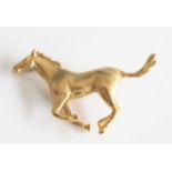 A 9ct yellow gold galloping horse brooch, with roller catch fastening, brooch length 39mm, gross