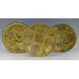 A matched pair of middle eastern slip glazed earthenware bowls, 19th century, each decorated with