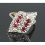 A yellow and white metal, ruby and diamond abstract navette shaped cluster ring, featuring two