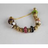 A sterling silver and 14ct yellow gold Pandora snake link bracelet, having a variety of rondels to