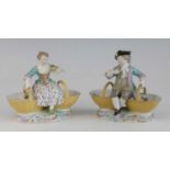A pair of Meissen porcelain figural table salts, late 19th century, each shown in 18th century
