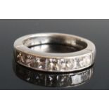 A platinum diamond seven stone half hoop eternity ring, comprising seven princess cut diamonds in