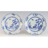 A pair of Chinese blue and white porcelain plates, 18th century, each decorated with a figure beside