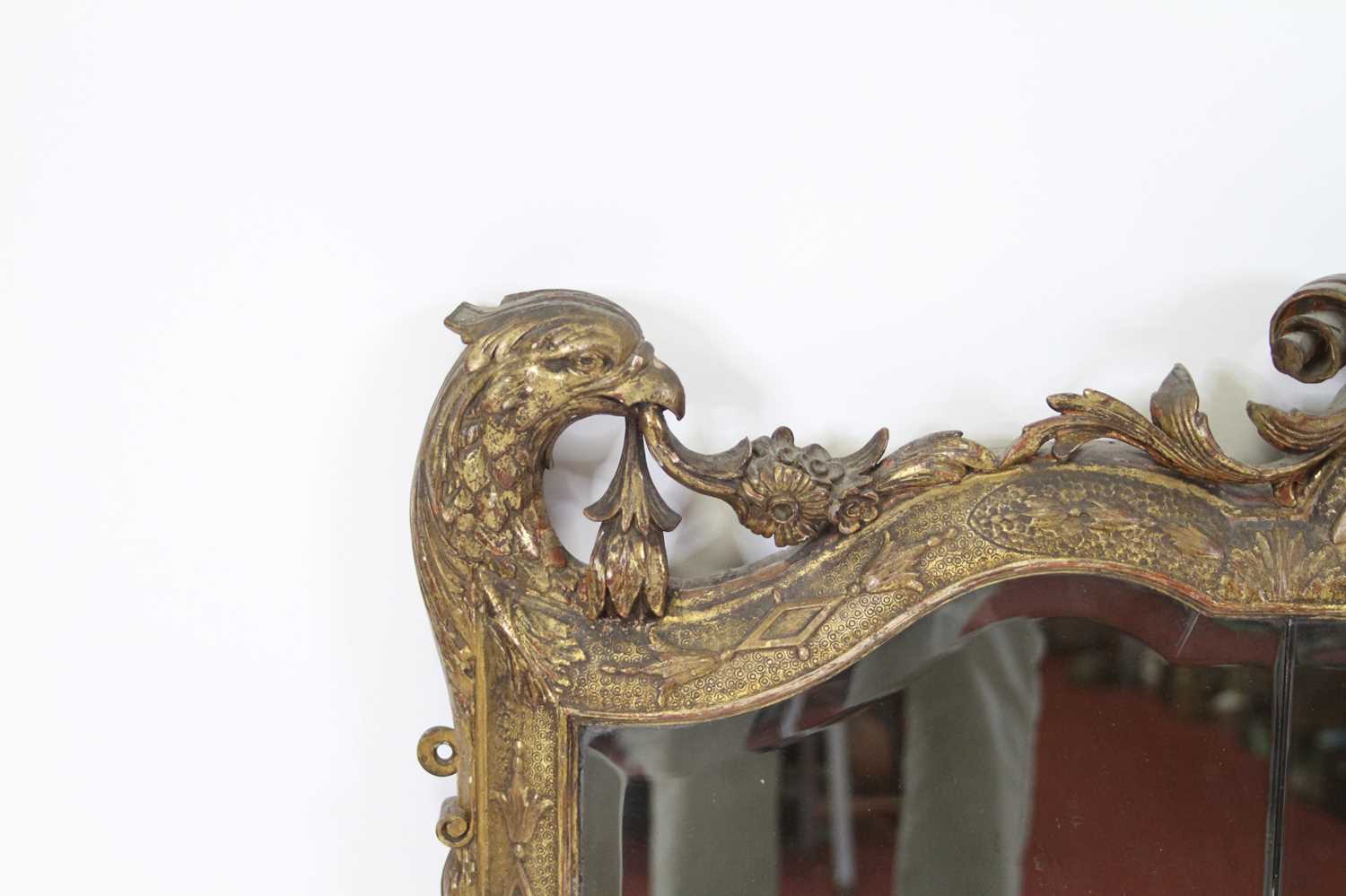 A 19th century giltwood and gesso overmantel mirror, having a triple shaped and bevelled mirrorplate - Image 2 of 4