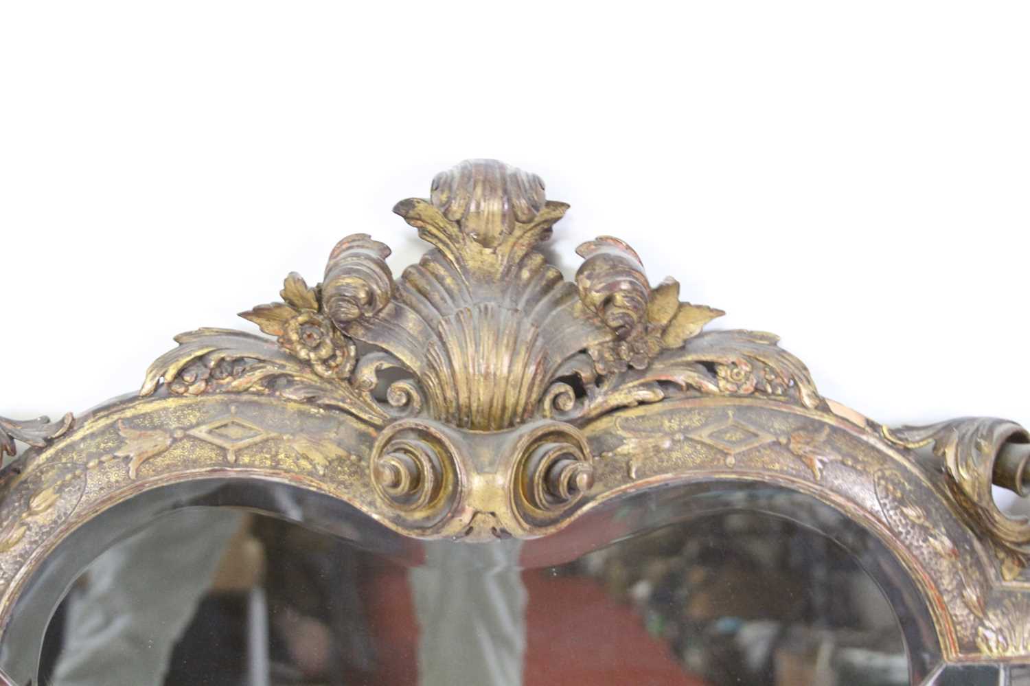 A 19th century giltwood and gesso overmantel mirror, having a triple shaped and bevelled mirrorplate - Image 3 of 4