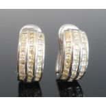 A pair of 18ct white gold half hoop earrings, each comprising three rows of nine, eleven, and nine
