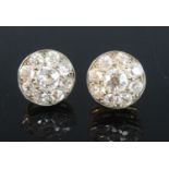 A pair of Edwardian yellow metal circular diamond cluster earrings, each with nine old European