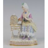 A Meissen porcelain figure of a lady, late 19th century, shown in 18th century dress, seated