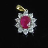 An 18ct yellow and white gold, ruby and diamond oval cluster pendant, featuring a centre oval