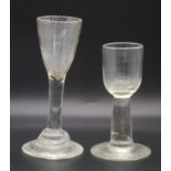 A wine glass, circa 1750, the round funnel bowl above a plain straight stem and terraced foot, h.
