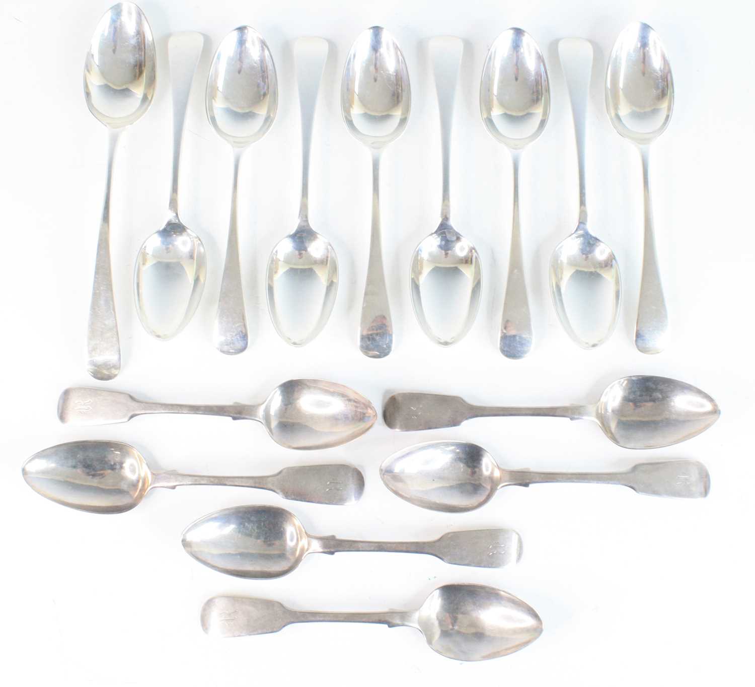 A collection of harlequin silver spoons, comprising a set of six Fiddle pattern dessert spoons,