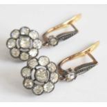 A pair of yellow and white metal diamond cluster drop earrings, each comprising a nine stone Old