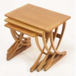 A 1970s Nathan teak nest of three occasional tables, having slightly rounded corners and crossbanded