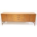 A 1960s Nathan teak long sideboard, having three graduated central drawers, with further single