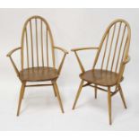 A pair of 1960s Ercol blond elm stickback 'Quaker' elbow chairs, having slightly dished seats and on