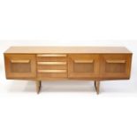 A 1960s Stonehill 'Stateroom' teak long sideboard, having three central drawers and single fall-