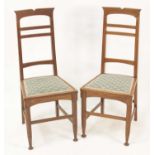 A pair of Arts & Crafts oak bedroom chairs, having horizontal slatted backs, Liberty style floral