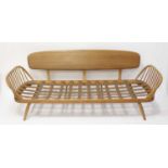 A 1960s Ercol light elm three-seater 'Surfboard' settee, having stickback end rails, removable