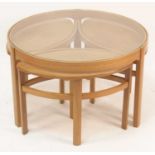 A 1960s Nathan Trinity teak nest of four occasional tables, the circular table with glass inset