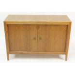 A 1960s Gordon Russell double door teak 'Helix' sideboard, having routed interlaced stencilled