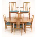 A 1960s Beithcraft teak dining suite, comprising; D-end extending dining table, having pull-out