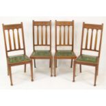 A set of four early 20th century walnut dining chairs by Shapland & Petter, having slightly recessed