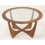 A 1960s G-Plan teak circular 'Astro' coffee table, having glass inset top raised on curved X-frame