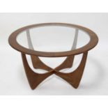 A 1960s G-Plan teak circular 'Astro' coffee table, having clear glass inset top on shaped X base,